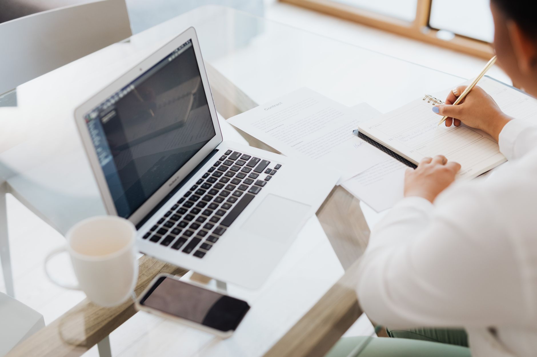 UK founder working at a desk with a laptop, reviewing campaign plans