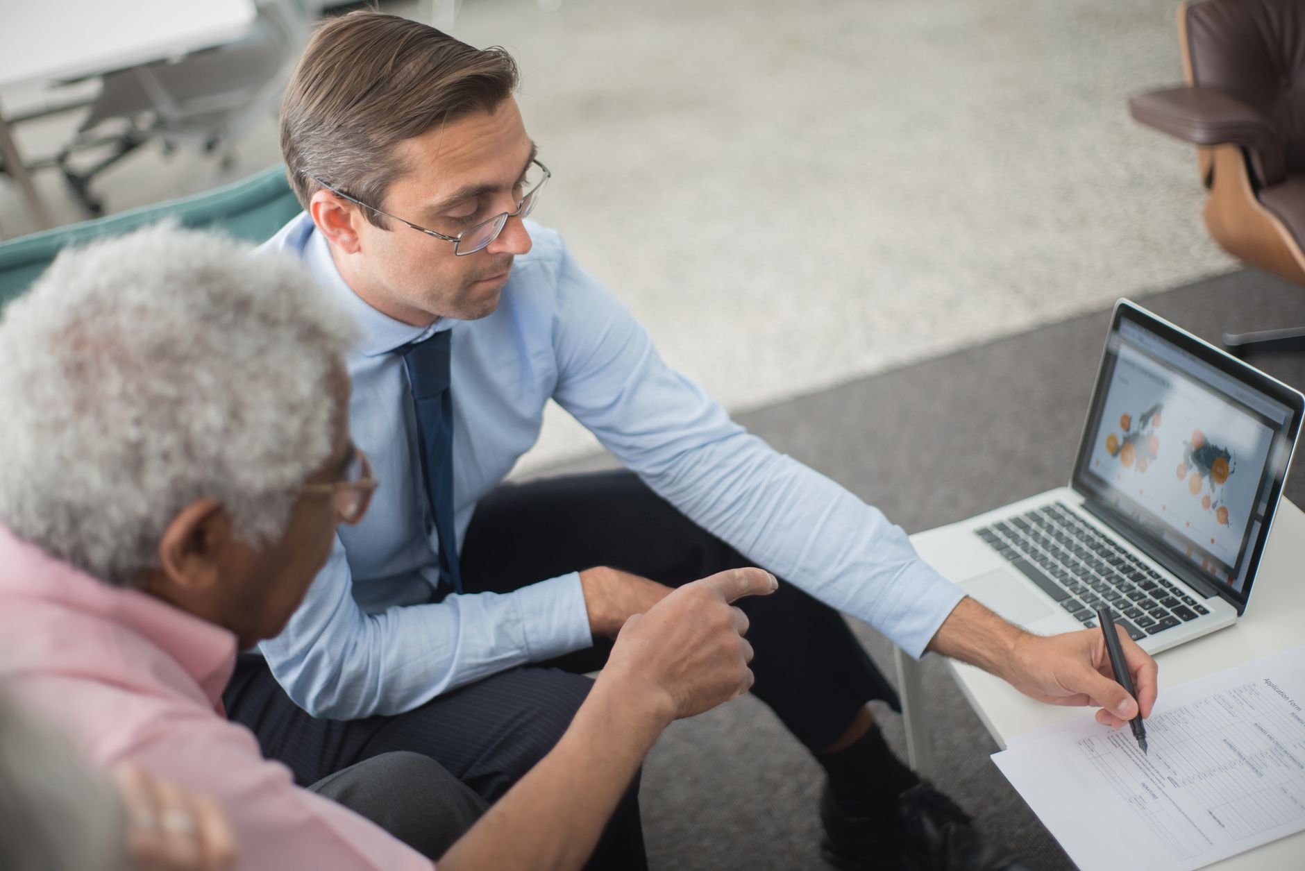 Founder and consultant discussing a Kickstarter campaign strategy on a laptop